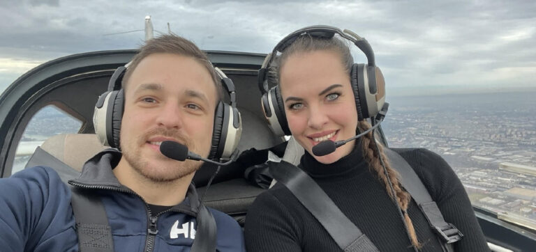 Two pilots taking a selfie in the cockpit of a small aircraft wearing Lightspeed Aviation's Zulu 3 and Lightspeed Delta Zulu headsets